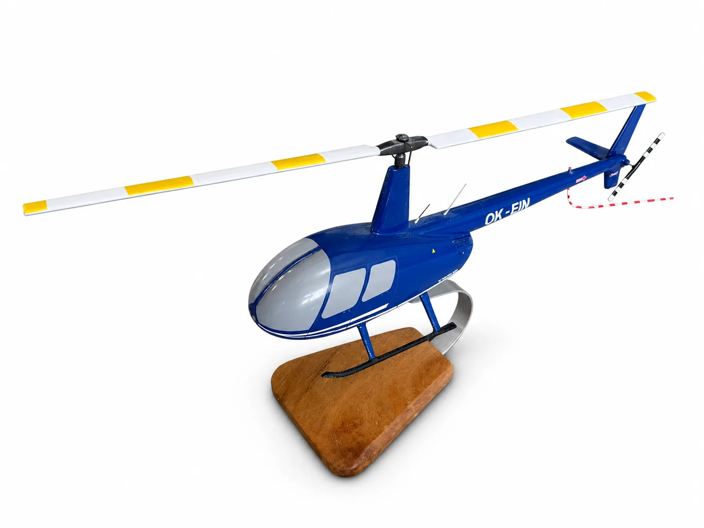 Handcrafted wooden Robinson R44 helicopter model in dark blue with registration OK-EIN on a solid wooden base