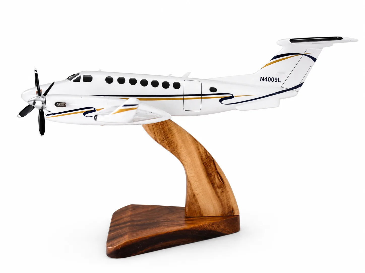 Handcrafted wooden Beechcraft King Air 350 model with navy and gold livery and registration N4009L on a wooden stand